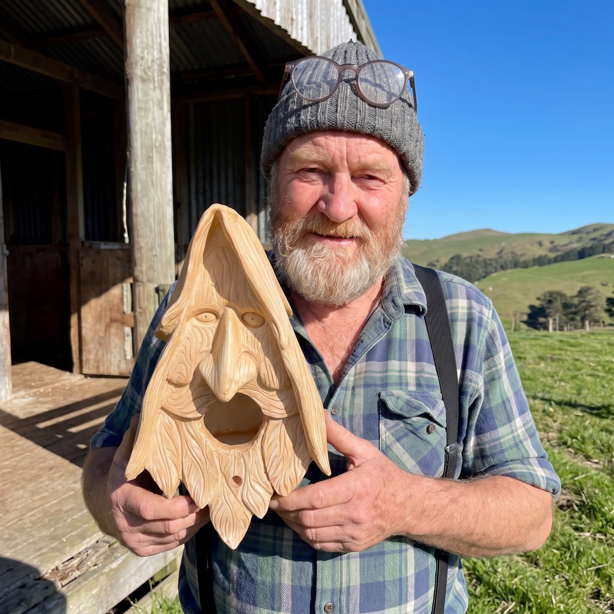 Dougal Fyfe holding one of his last carved birdhouses