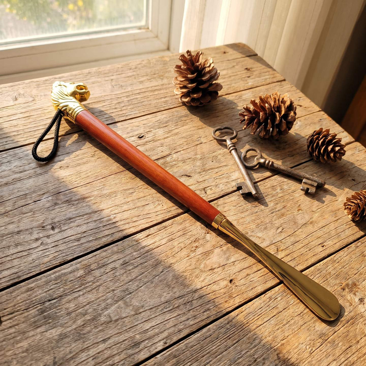 Lyle's long shoe horn with gold lion head and hardwood handle