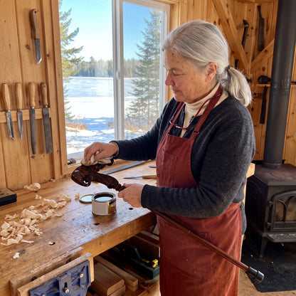 Odette Thibodeau rubbing oil into a carved elephant-head grip