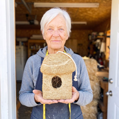 Marj Fraser holding one of her last roosting huts