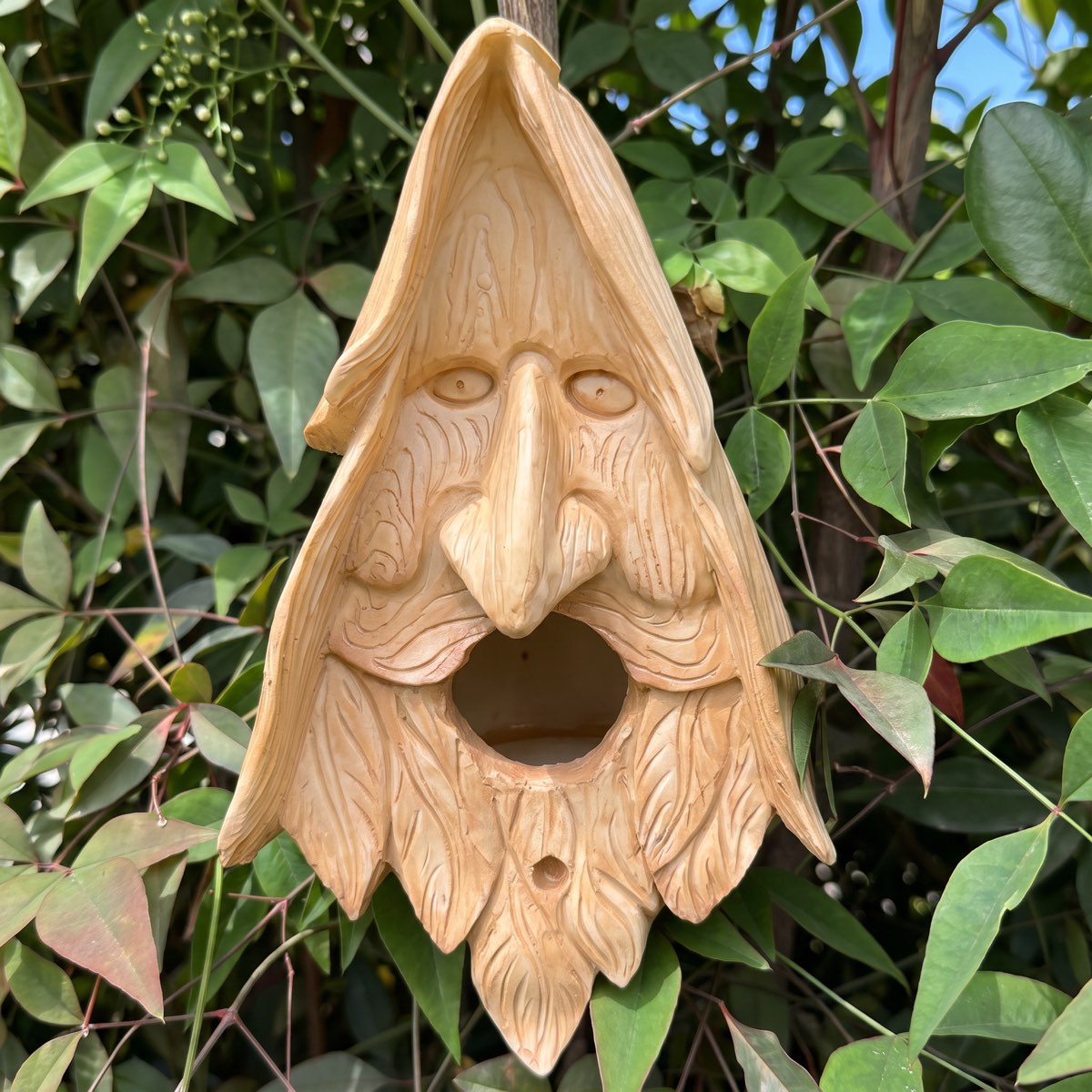 Close-up of the carved face of the wood spirit birdhouse