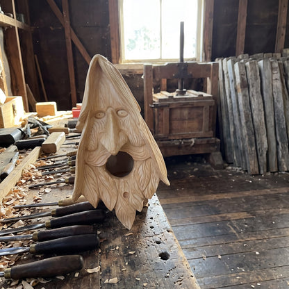 Wood spirit birdhouse on the workbench in Dougal's shearing shed