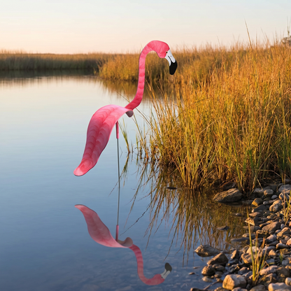 Watermelon pink hand-painted flamingo wind-spinner by a pond