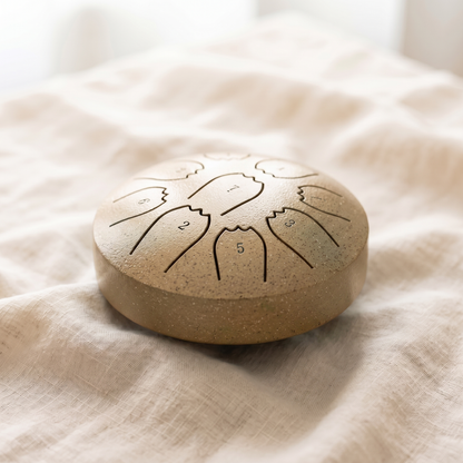 Standard rain drum in warm golden metallic finish on linen