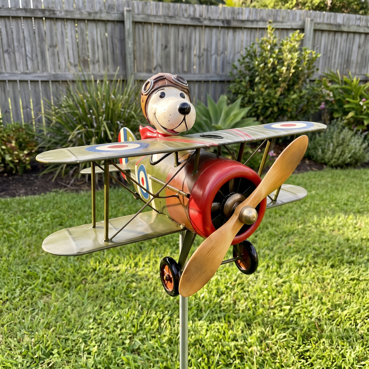 Flying Ace biplane wind spinner on its stake in a garden lawn