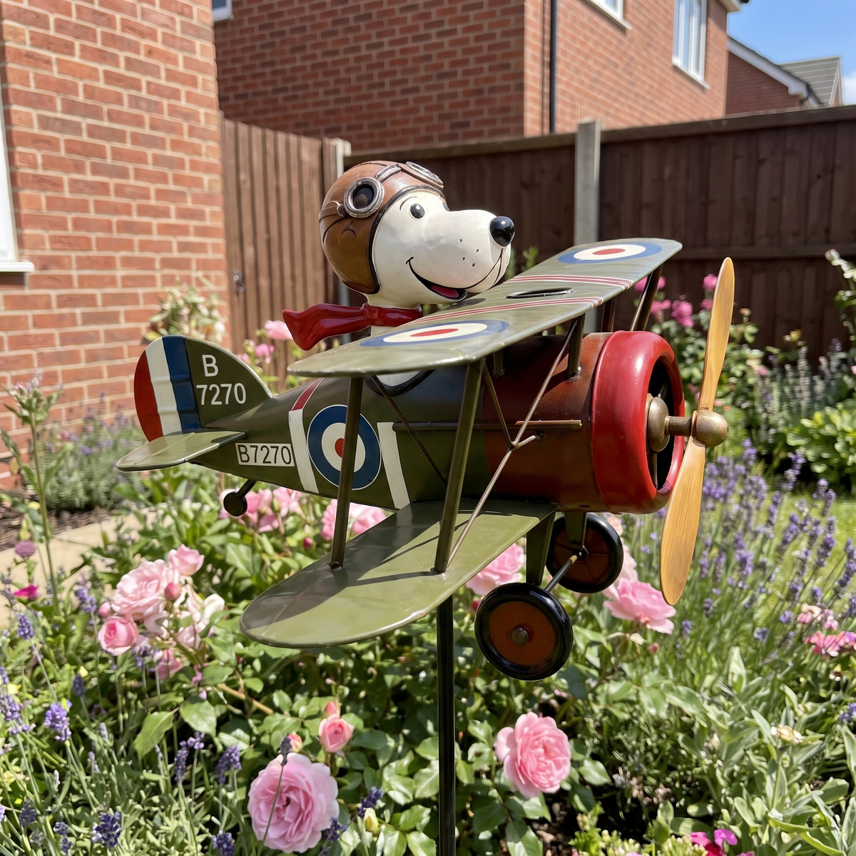 Dennis's Flying Ace biplane wind spinner in an English flower border