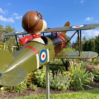 Biplane wind spinner from behind, tail fin and pilot against a blue sky