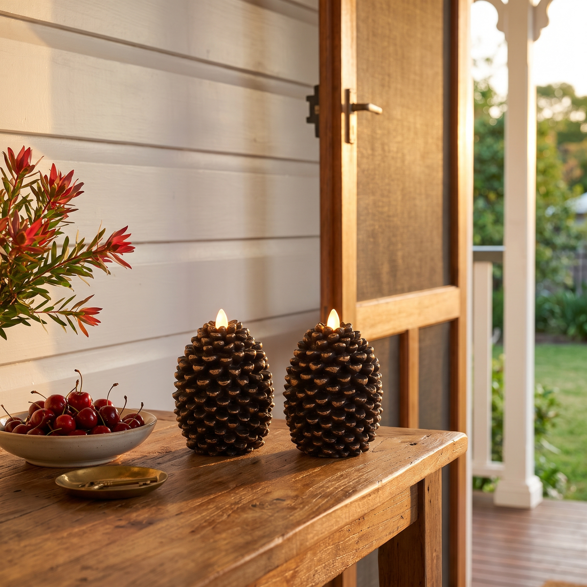 Dulcie's flameless pinecone candles, pair of two, glowing on a hall table