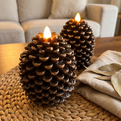Close-up of the bronze-tipped flameless pinecone candle with its glowing flame