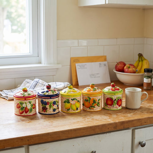Imogene's hand-painted fruit jars in all five fruits on a kitchen counter
