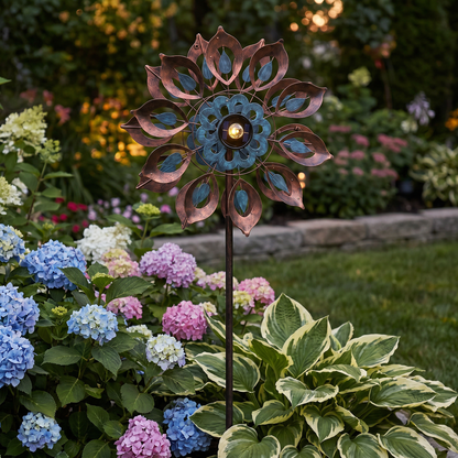 Lily solar wind spinner installed in a flower garden