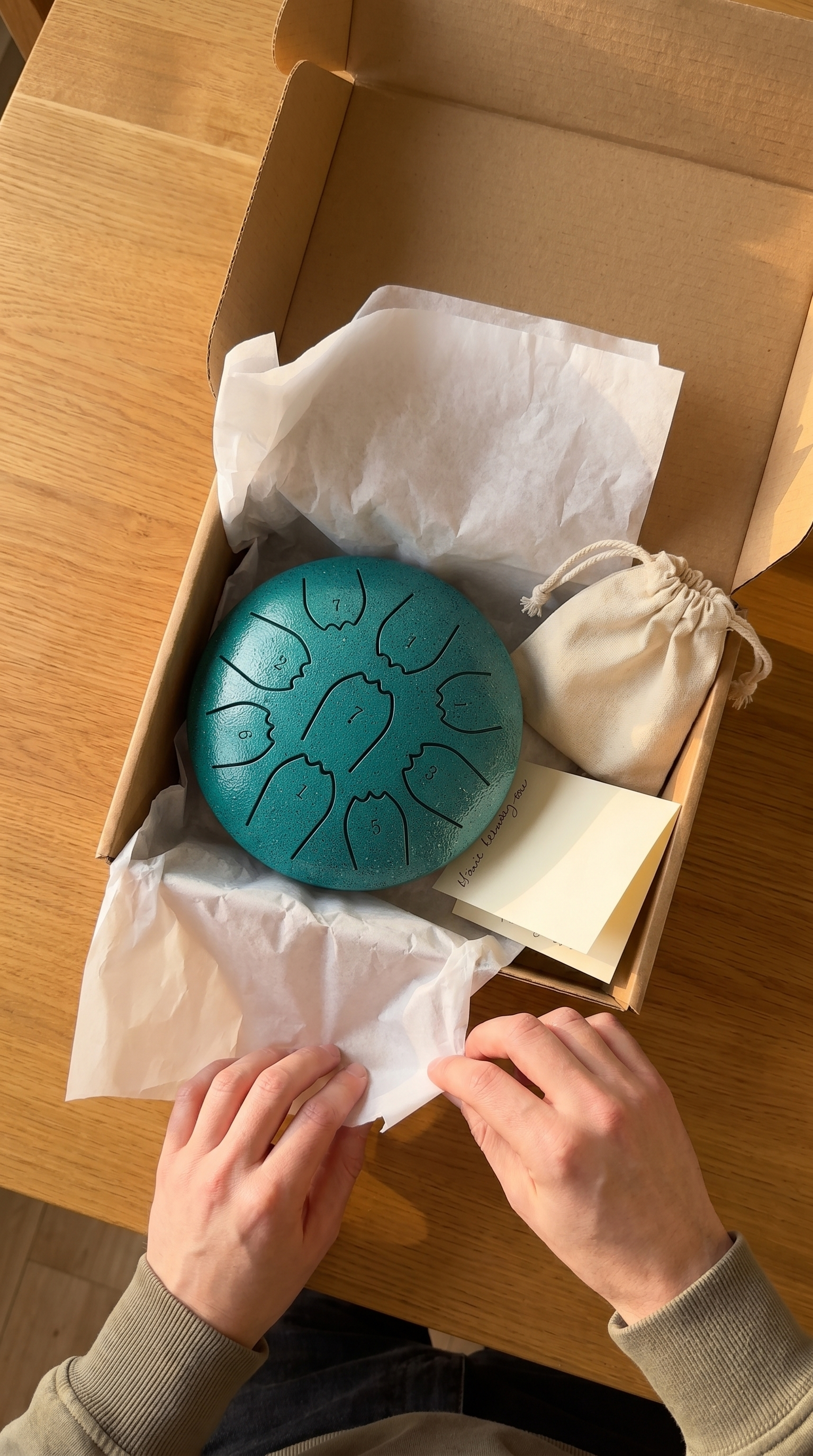 Rain drum unboxing - open box with drum, pouch, handwritten note