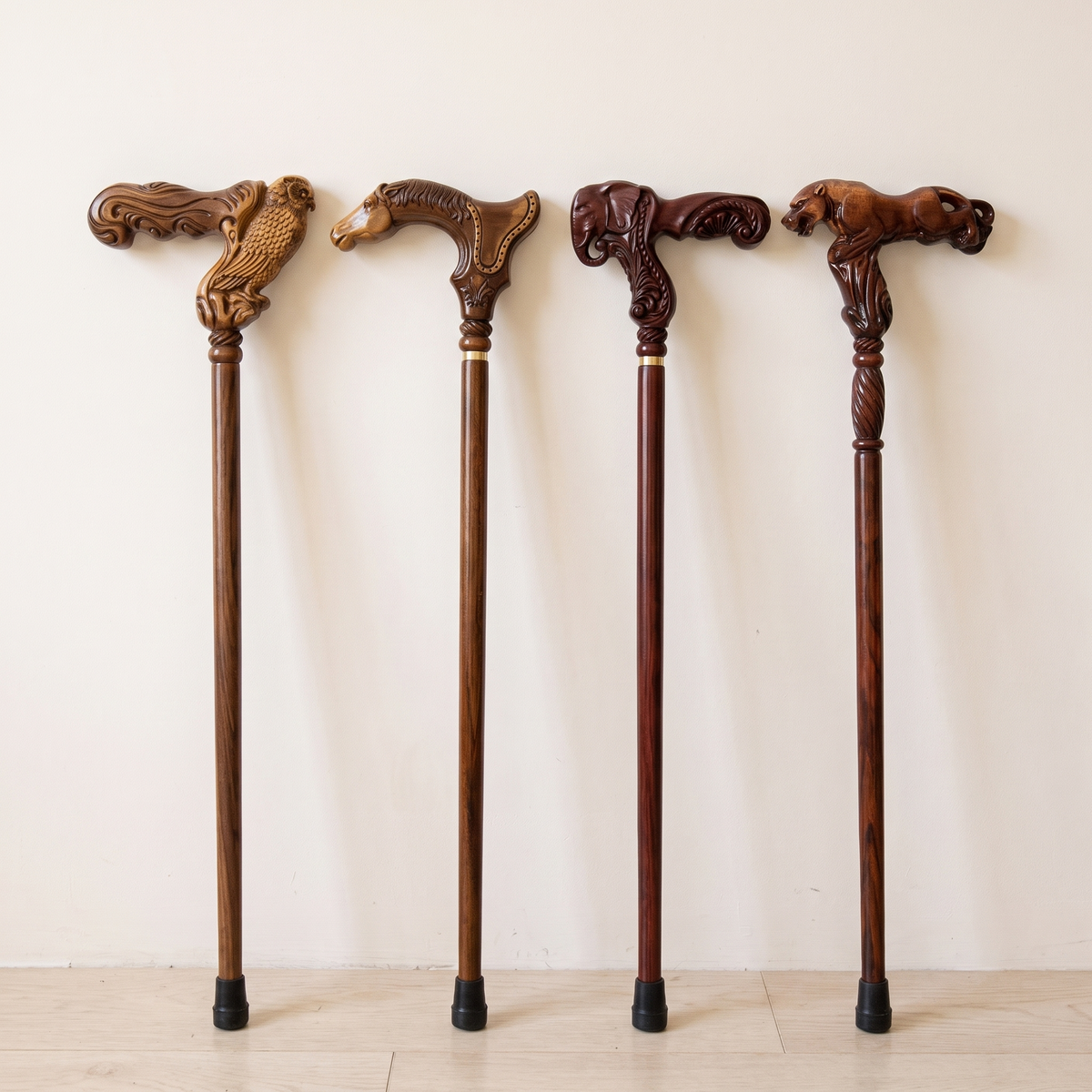 Four hand-carved wooden canes standing side by side: owl, horse, elephant and leopard grips