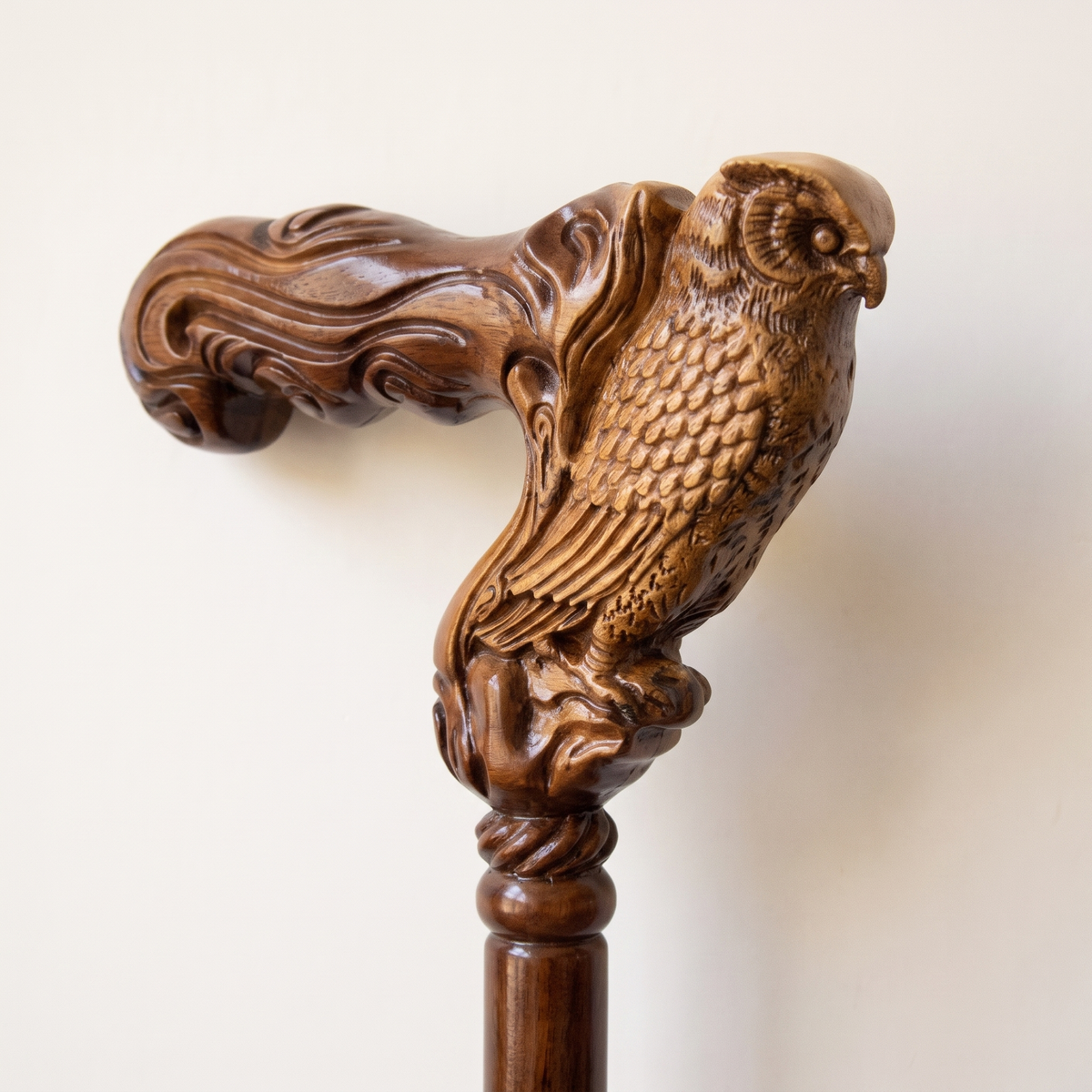 Close-up of the carved owl grip with layered feather detail