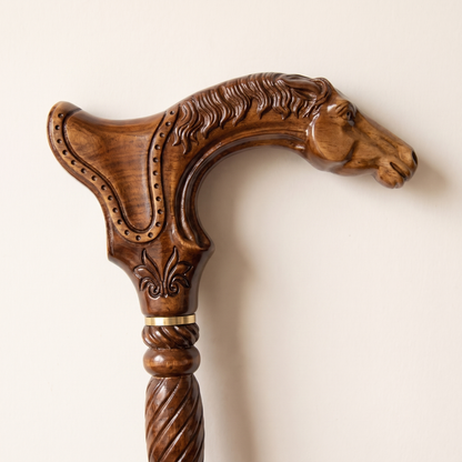 Close-up of the carved horse head grip with flowing mane and brass collar