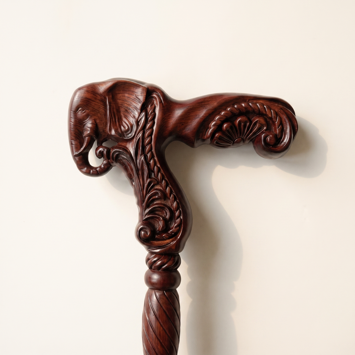 Close-up of the carved elephant head grip with curled trunk