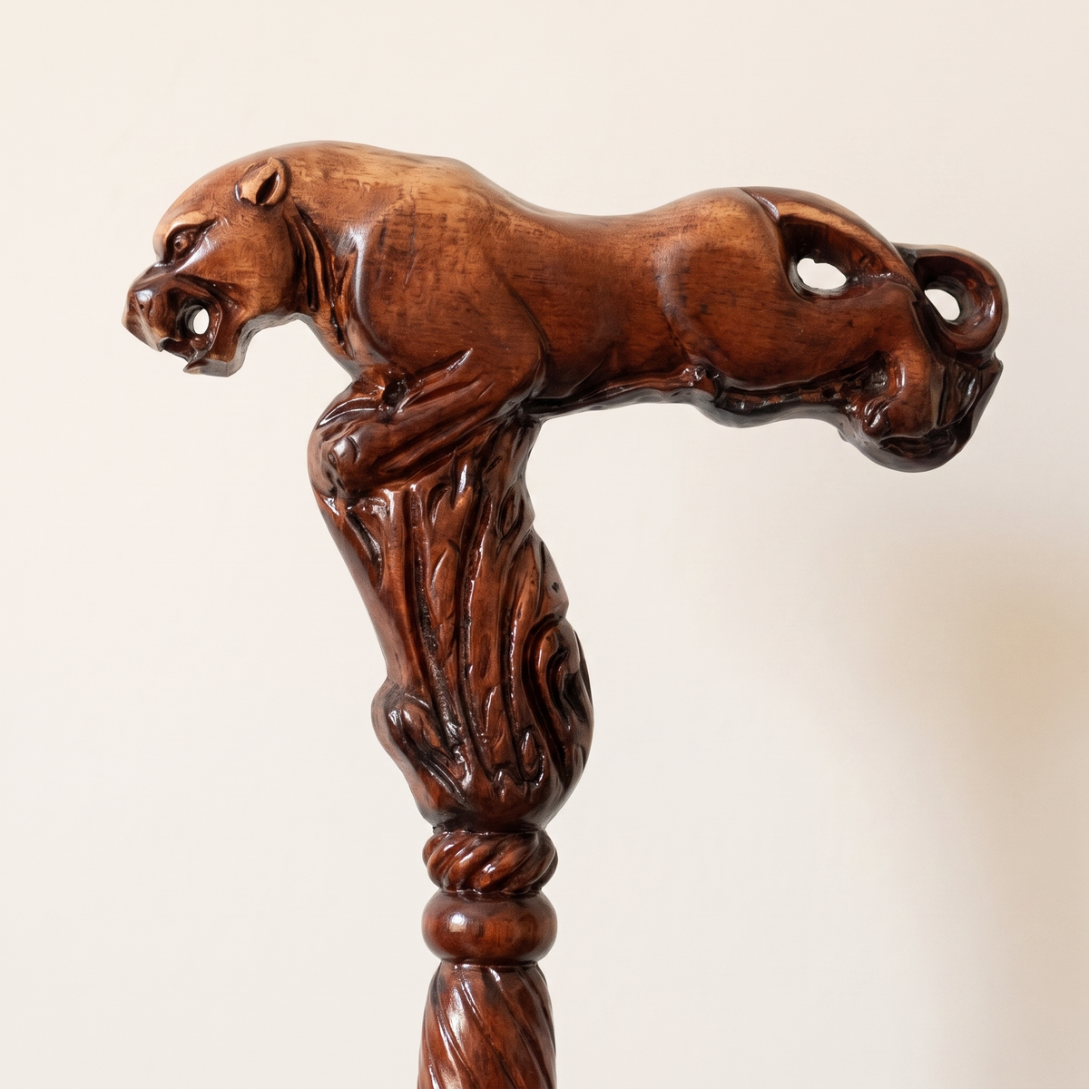 Close-up of the carved leopard grip stretching along the handle