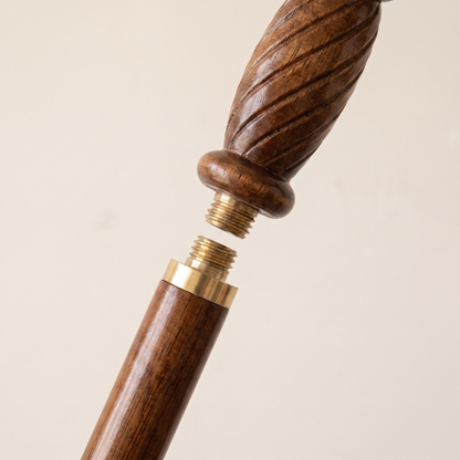 The brass collar unscrewed, showing the joint that lets the cane come apart for travel