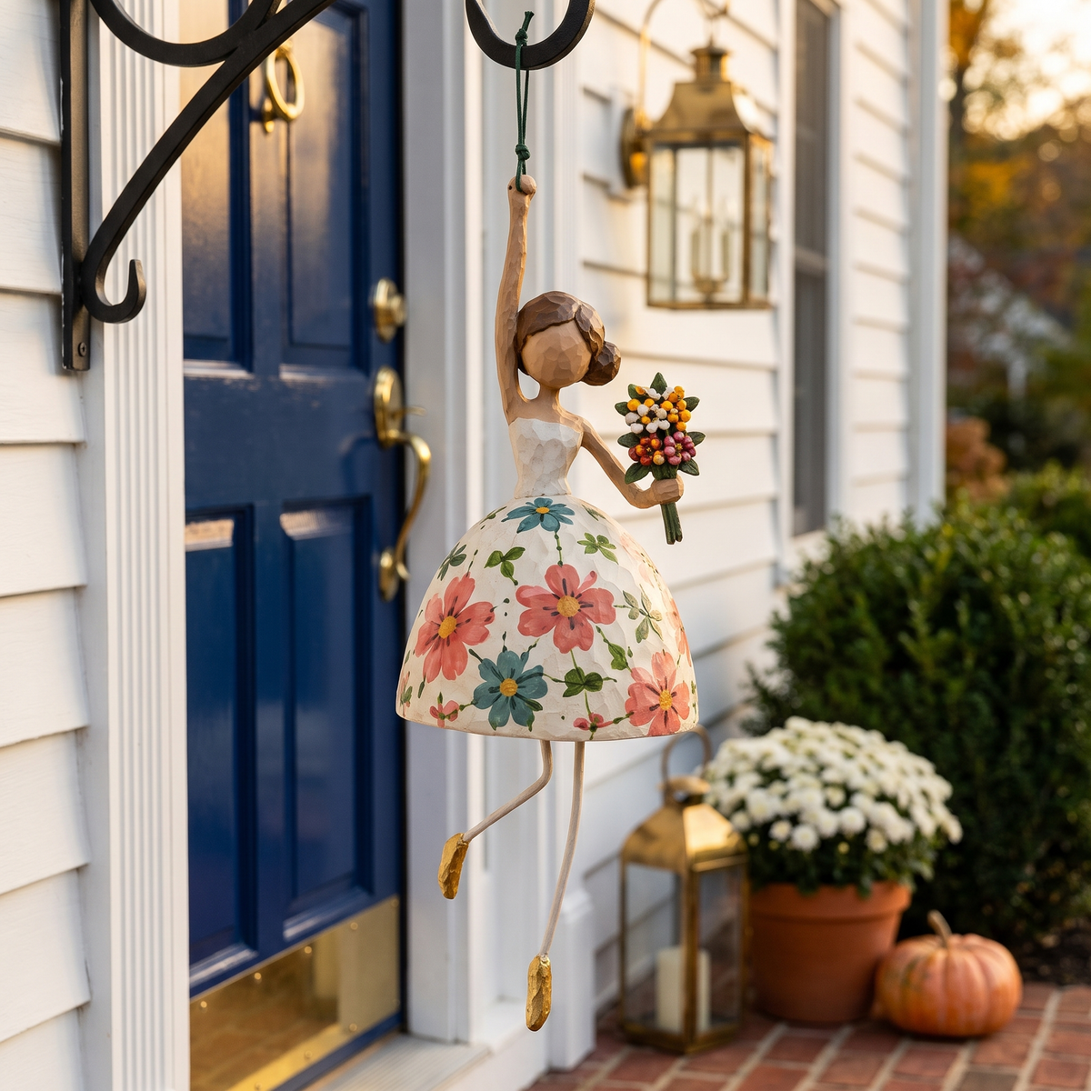 The Bouquet wind dancer hanging beside a navy front door